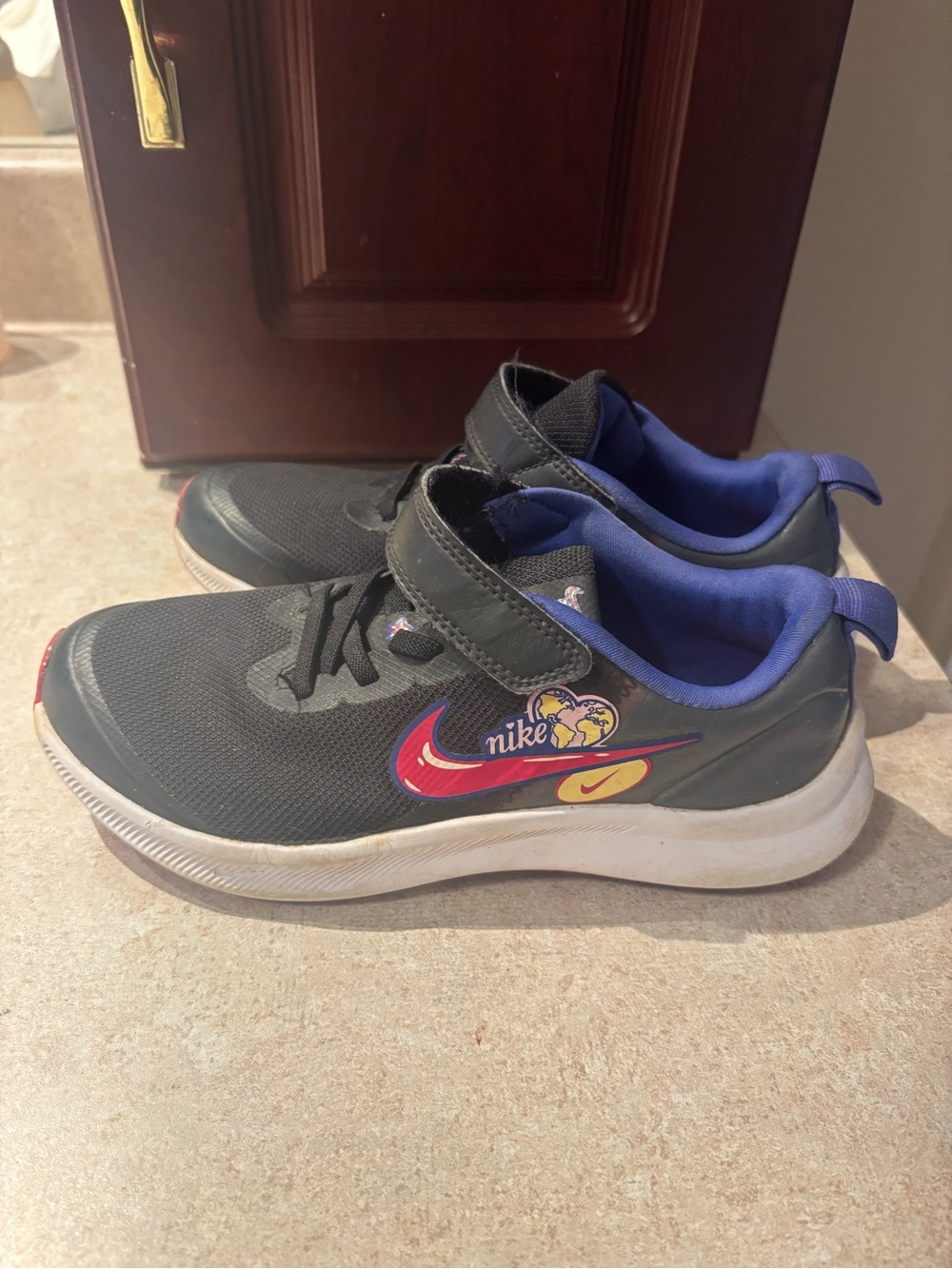 Nike Kids Black Sneakers with Blue Lining and Red Swoosh
